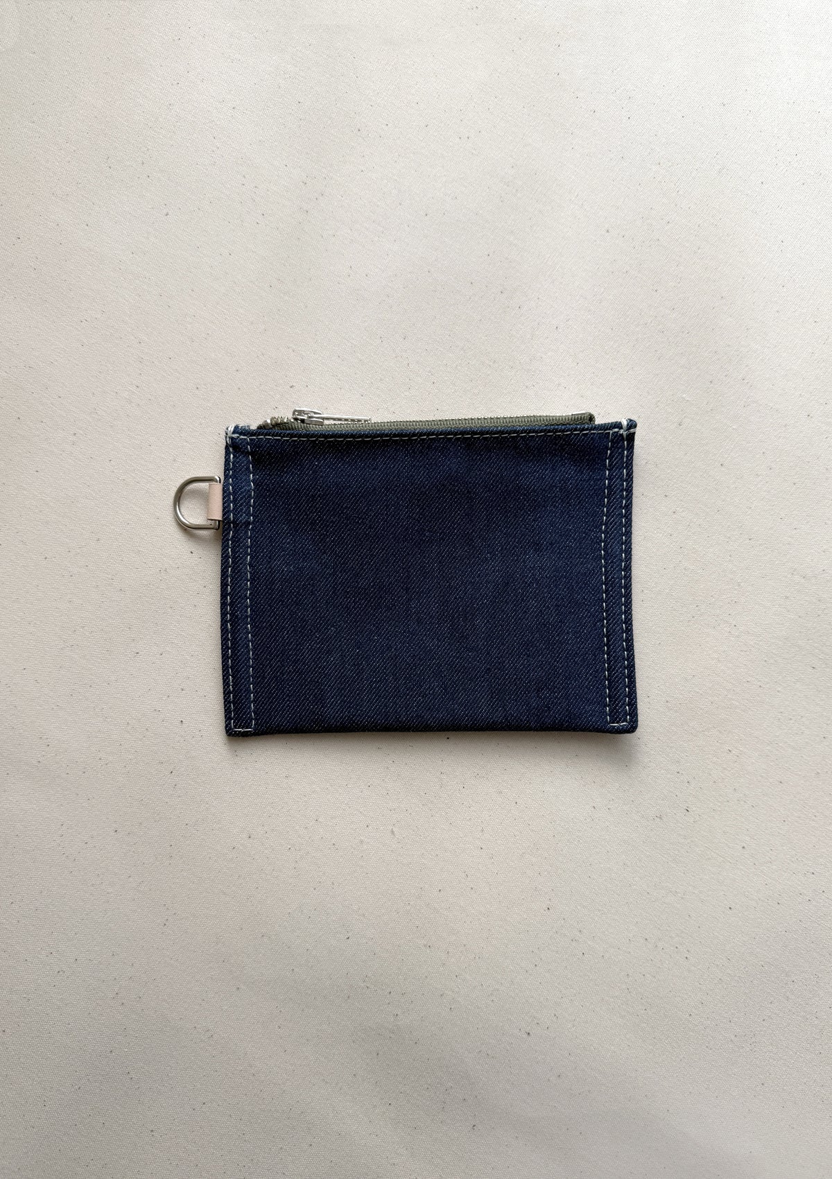 The reclaimed canvas small flat pouch in denim