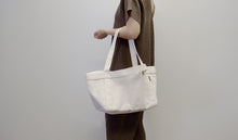 Load image into Gallery viewer, model holding grand day tote in natural color
