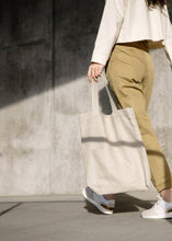 Load image into Gallery viewer, Model holding the Mitaka large bag
